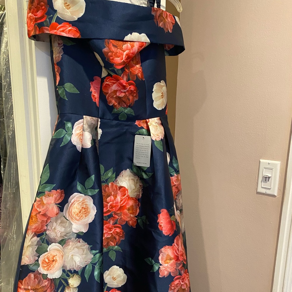 Floral cocktail dress, uneven length. Longer back